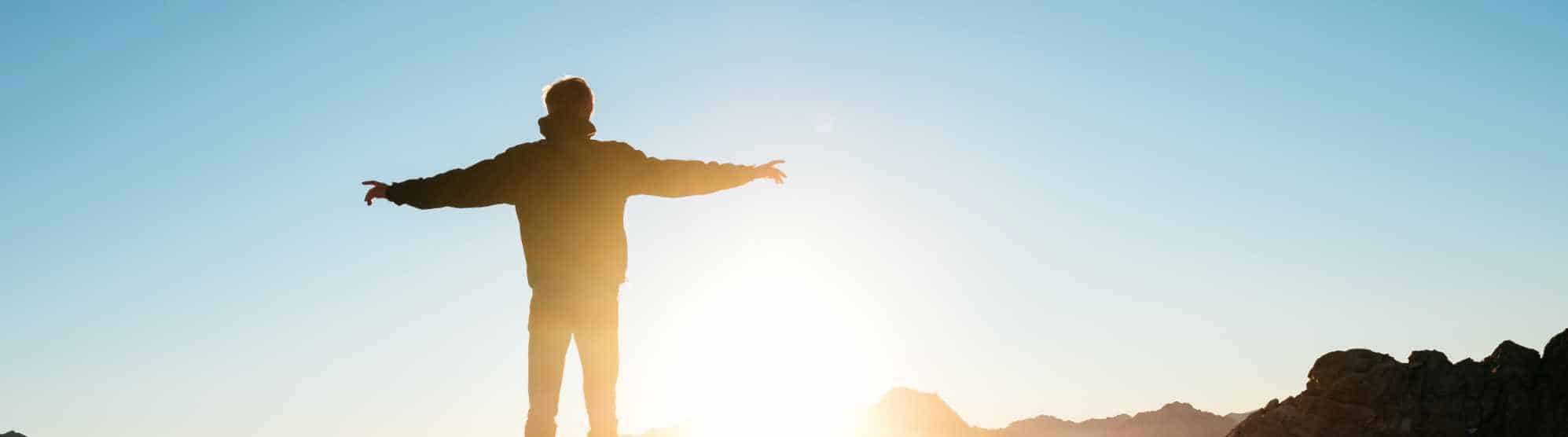 person embracing the sunrise as part of therapy